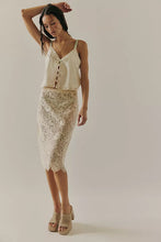 Free People ivory cami styled with a lace midi skirt, highlighting its romantic silhouette
