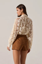 Romantic white lace blouse styled with brown high-waisted shorts
