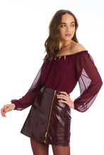 Model wearing burgundy faux leather River Skirt with gold zipper by ALLISON New York