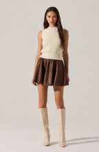 Ivory knit vest with delicate ruffle trim and floral pearl button closures