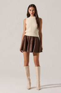 Ivory knit vest with delicate ruffle trim and floral pearl button closures