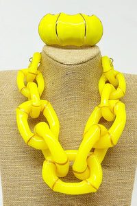 Close-up of the Michelle Necklace in yellow showcasing curved bamboo-inspired links and gold detail