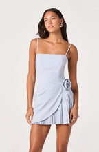 The ASTR the Label Blake Pleated Mini Dress in powder blue — structured boning, a rosette hip detail, and a dramatic cutaway pleated hem.