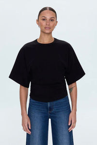 Fitted black tee with cinched sides and shirttail hem