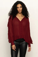 Model wearing the Harmony Blouse in Crimson