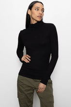 Model wearing black ribbed Essential Turtleneck by Sanctuary