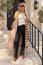 Sgt. Pepper Captain Duster in Leroy Brown, camel velvet with brown embroidery, modeled at a Mediterranean-style hotel.