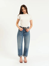 Model wearing DAZE Venice Barrel Long With Cuff jeans in “The Blues” wash. High-rise barrel leg fit with a pre-rolled cuff, styled casually with a tucked-in white tee and heels.