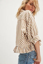 Relaxed collared shirt with cuffed sleeves and subtle peplum-style hemline