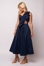  navy one-shoulder midi dress with oversized twisted bow, front cut-out, and A-line skirt. 