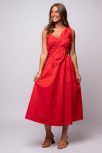 Red midi dress with asymmetric neckline, oversized bow detail, and side cutout