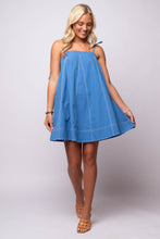 blue contrast top stitch mini dress with white stitching, adjustable straps, and side pockets.