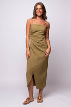  olive green midi dress, featuring asymmetrical pleats, spaghetti straps, and a front slit