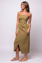  Midi Dress by En Saison in olive green, featuring asymmetrical pleats, spaghetti straps, and a front slit midi silhouette.