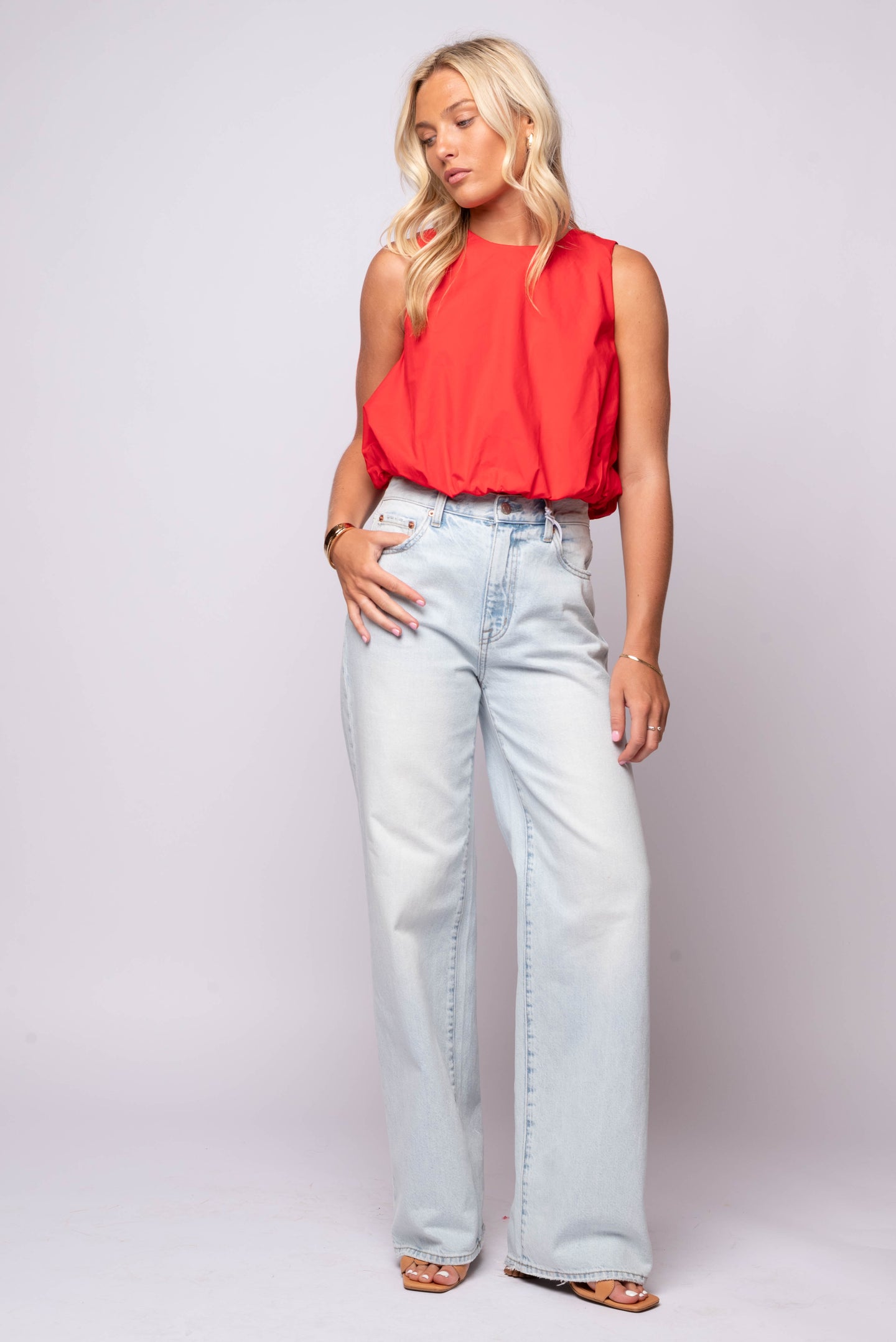 bright red sleeveless crop top with a round neckline and blouson elastic hem