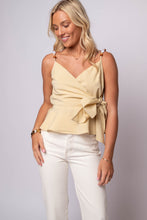 Lowen Wrap Peplum Top by En Saison with waist tie, peplum hem, and beaded shoulder straps in light yellow