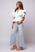 white flutter sleeve peplum top with  cinched waist