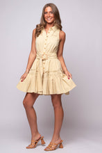 light yellow mini with a belted waist, ruffle pockets, and button-down front.