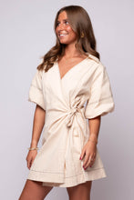 beige wrap mini dress with puff sleeves, and a tie waist