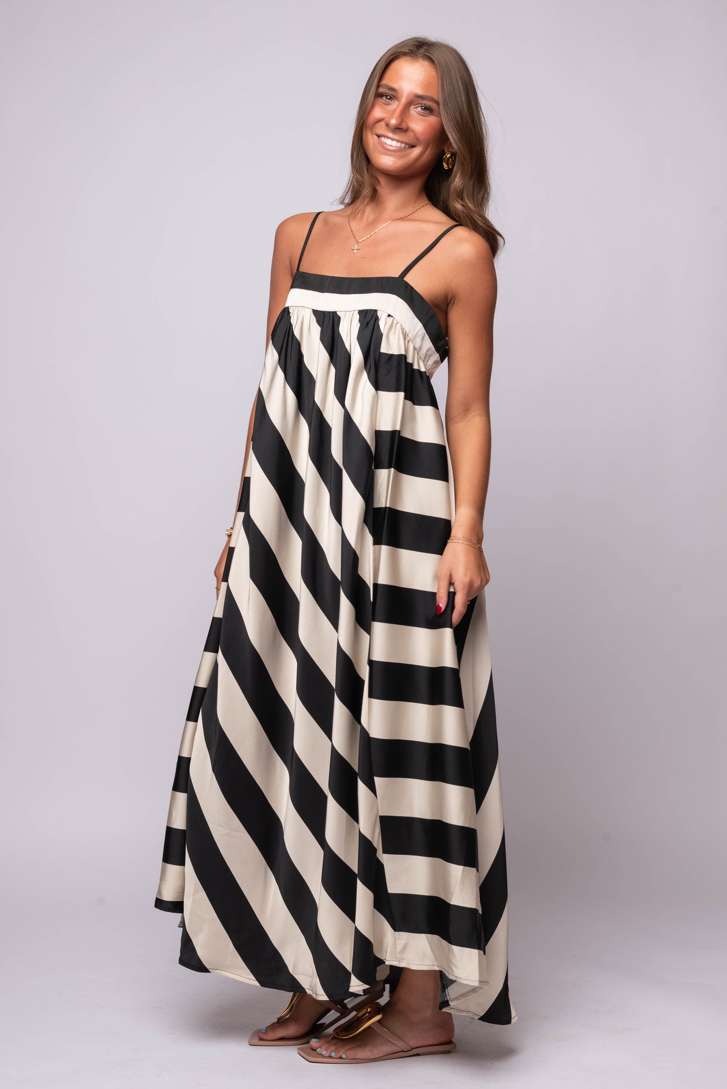 Flowy black and cream diagonal striped maxi dress with adjustable straps and contrast necklin