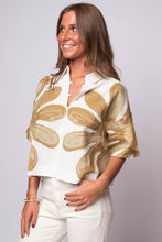Cleobella  topwith oversized golden floral print.