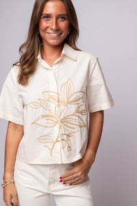 The Sol Stitch Button-Up – short sleeve cotton shirt with tonal embroidery, relaxed fit, and front buttons.