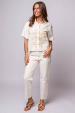 Short sleeve cotton shirt with tonal embroidery, relaxed fit, and front buttons.
