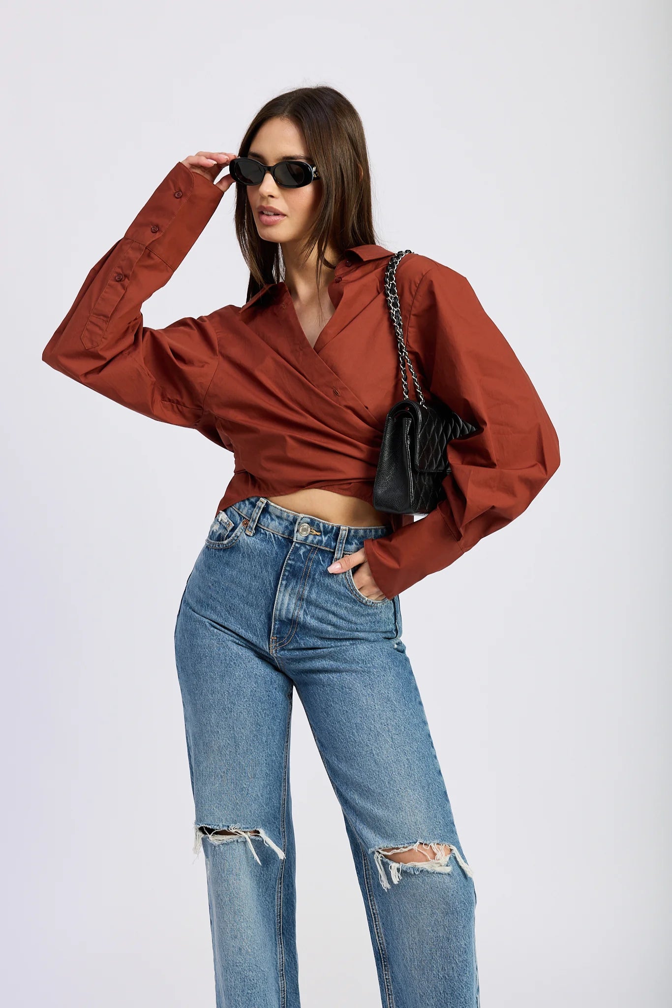Brick red oversized wrap shirt with exaggerated sleeves and a tie-back waist
