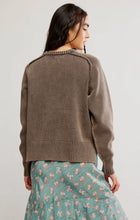 Relaxed brown pullover styled with a floral midi skirt