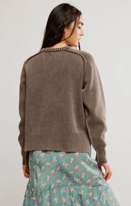 Relaxed brown pullover styled with a floral midi skirt