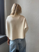 Cream Aja Sweater with a mock neck and wide sleeves