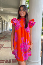 bright orange mini dress with large fuchsia floral print and ruffled sleeves,