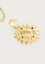 Close-up of Milos Soleil Charm – hand painted enamel gold sunburst pendan