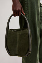 Free People Barlow Dark Olive bucket bag carried by handle