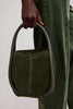 Free People Barlow Dark Olive bucket bag carried by handle