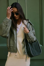 Free People Barlow bucket bag worn on shoulder, model view