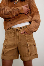 Close-up of cotton-linen cargo short showing flap pocket detail and washed finish