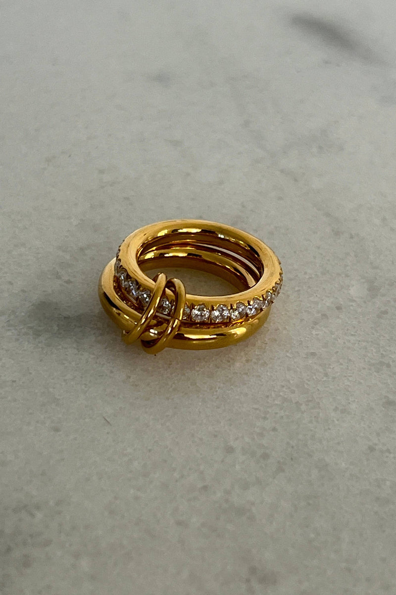 The Grace Ring in gold with pavé crystal detail styled on hand with watch and bracelets