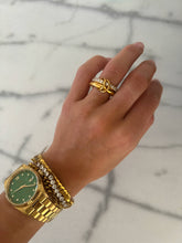 The Grace Ring in gold with pavé crystal detail styled on hand with watch and bracelets