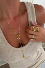 Sadie Necklace with gold toggle and orb pendant styled with neutral ribbed tank