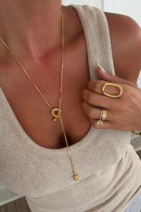 Sadie Necklace with gold toggle and orb pendant styled with neutral ribbed tank