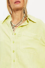 Close-up of patch pocket detail on Free People linen top