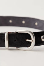 Sleek leather belt with brass accents and worn-in vibe