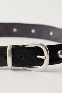 Sleek leather belt with brass accents and worn-in vibe