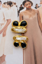 Easton Elle Arch Earrings Black Onyx, enhanced product photograph on fashion magazine