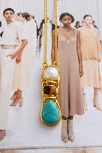 Easton Elle Capri Slip Necklace with pearl, tiger’s eye and turquoise pendant on a fashion magazine