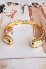 Easton Elle Misty Cuff Cross, enhanced product photograph on fashion magazine
