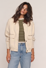 Heartloom Halli Jacket in Ecru, model wearing the cream jacket over a striped top.