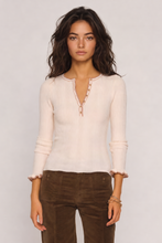 Heartloom Pine Top in Ivory, model view showing the button neckline and long sleeves.