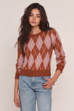 Heartloom Sweeney Sweater in Spice, model wearing the pink and brown argyle sweater with blue jeans.